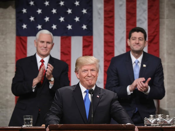 President Donald Trump pauses as delivers his first State of the Union address Tuesday, Jan. 30, 2018 in Washington, as Vice President Mike Pence and House Speaker Paul Ryan applaud.